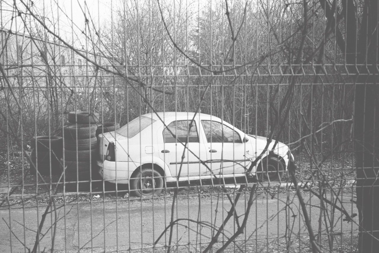 Dacia car alongside car tires next to the car repair shop